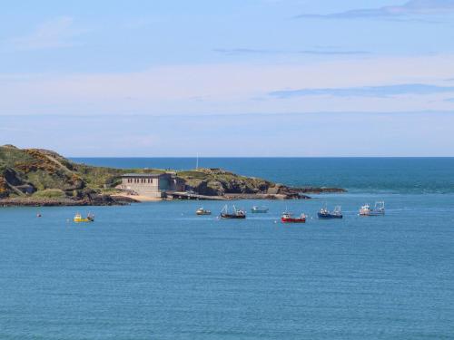 a group of boats in a large body of water at Sea Cliff in Pwllheli