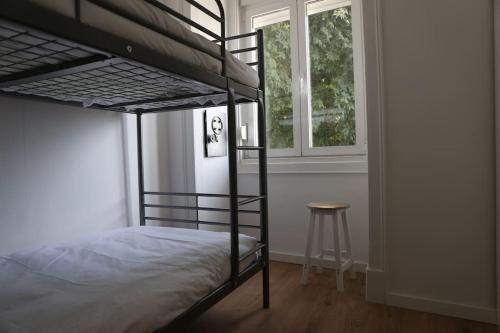 a bedroom with a bunk bed and a stool at Near the River 3 Bedrooms Flat, with AC for 9 in Lisbon