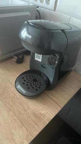 a black coffee maker sitting on top of a counter at Citadelle Apart in Alba Iulia