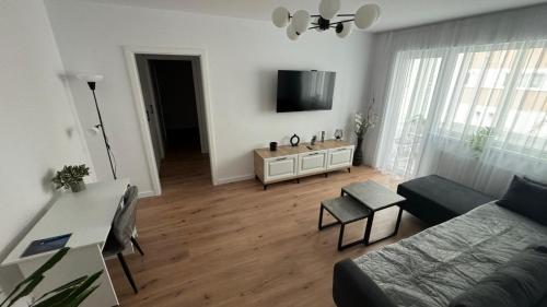 a living room with a couch and a flat screen tv at Citadelle Apart in Alba Iulia