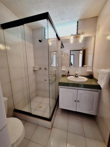 a bathroom with a shower and a sink and a toilet at Apartamento Melgar, Villa Flórez in Melgar