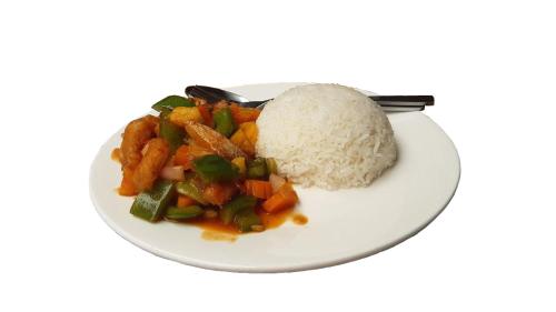 a white plate with rice and vegetables and a spoon at Naraya Guesthouse in Phnom Penh