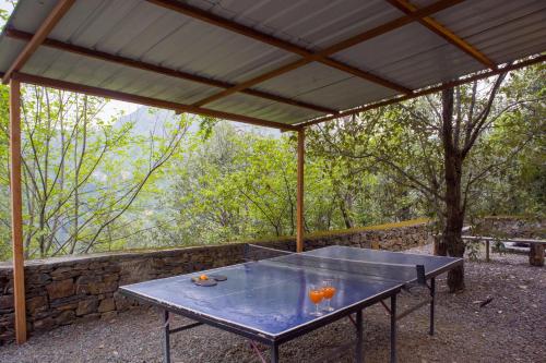 a table with two oranges on it under a canopy at Alaya Stays Duplex Cottage with Tree House - Suro Woodcrest Chalet in Shogi