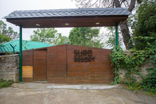 a wooden gate with amind limit ahead sign on it at Alaya Stays Cottage with Tree House - Suro Woodbine Chalet in Shogi