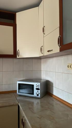 a microwave sitting on top of a counter in a kitchen at BT Lux apartment 2 in Skopje