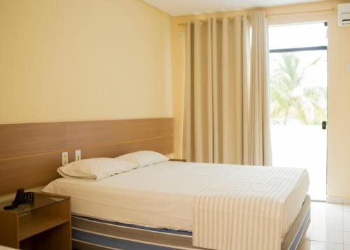 Postel nebo postele na pokoji v ubytování Fiesta Park Hotel