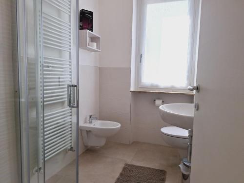 a bathroom with a sink and a toilet and a window at Re Lear Expo in Verona