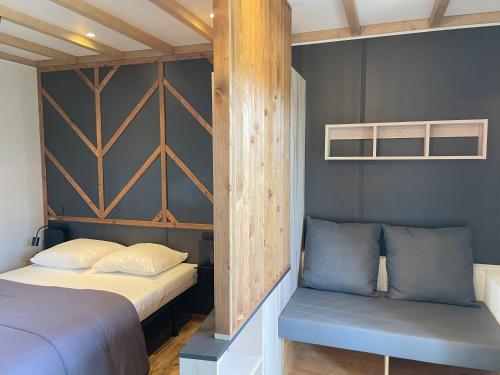 - une chambre avec 2 lits et un banc dans l'établissement Chalet Camping du grand fay, à Saint-Père-en-Retz