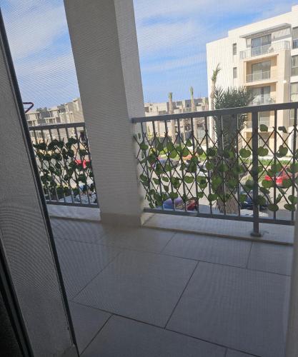 a balcony with a view of a building at Marassi luxury 2 bedroom in El Alamein