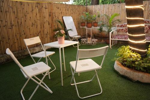 a group of chairs and a table in a yard at Hostell One - A complete backpacker & Coworking Hub in Pune