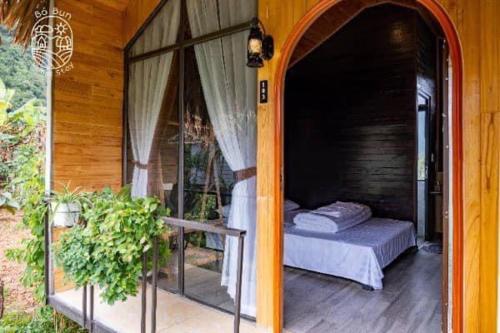 a room with a bed on a porch at Bó Bun Homestay Mộc Châu in Mộc Châu