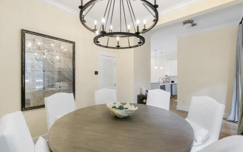 a dining room with a wooden table and white chairs at Ritz Clareon by Oversee 30A in Seacrest