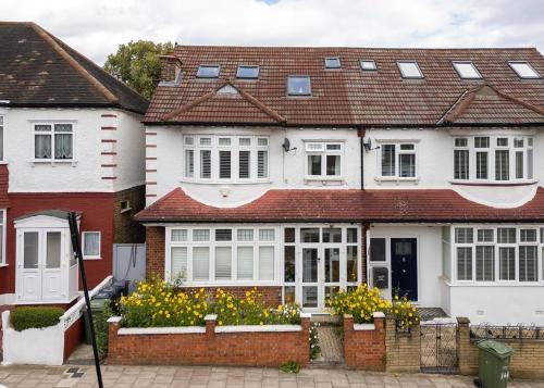a white house with a red roof at Wavertree Hotel in London