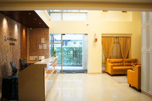 a lobby with a yellow couch and a waiting room at AK Castle Suites in Bengaluru