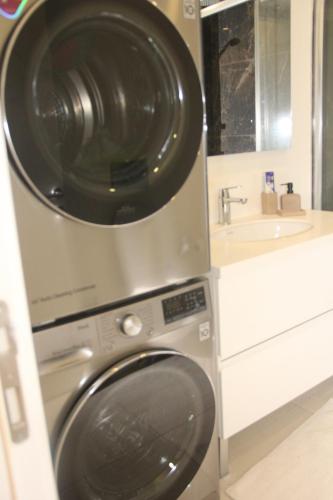 a washer and dryer in a bathroom with a sink at Lovely One Bedroom Appartment-530 in Istanbul
