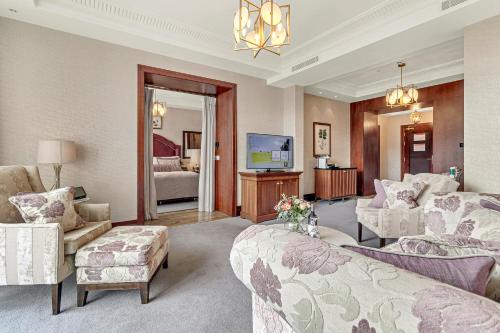 a living room with a bed and a couch and a tv at Fota Island Hotel and Spa in Fota Island