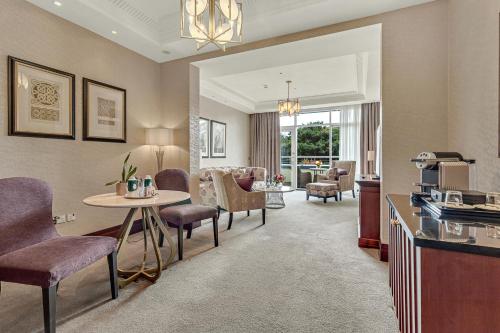 a room with a table and chairs and a living room at Fota Island Hotel and Spa in Fota Island