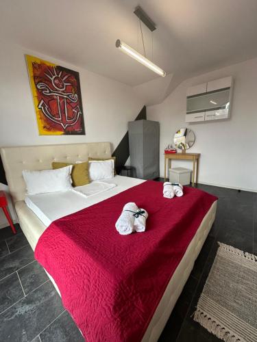 a bedroom with a large bed with two stuffed animals on it at Vitamine Central Apartment in Craiova