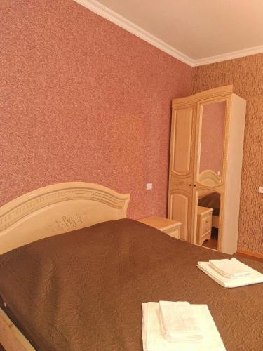 a bedroom with a bed and a cabinet and a mirror at Vardzia2022 in Vardzia