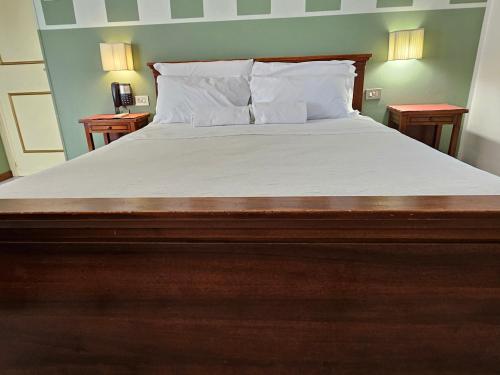 a bedroom with a large bed with white sheets and pillows at Hotel Rosalba Perugia in Perugia