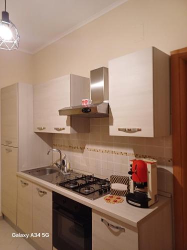 a kitchen with a stove and a sink at Civico18 in Fiumicino