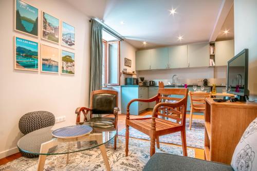 un salon avec une table et des chaises et une cuisine dans l'établissement Le Rocher - Chamonix Hypercentre - Refait à Neuf, à Chamonix-Mont-Blanc