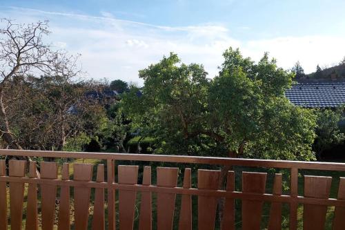 a wooden fence with trees in the background at Klasický dům, 5 ložnic , 5 bedrooms, Praha in Prague