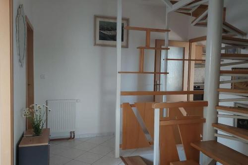 a room with wooden spiral stairs in a room at Klasický dům, 5 ložnic , 5 bedrooms, Praha in Prague