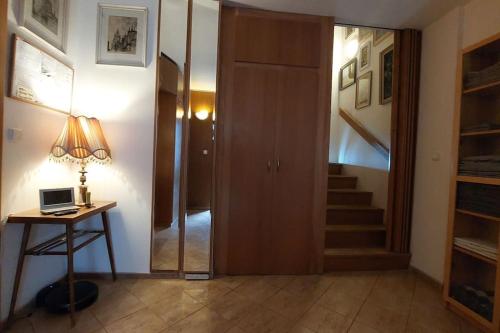 a hallway with a door and a table with a lamp at Klasický dům, 5 ložnic , 5 bedrooms, Praha in Prague