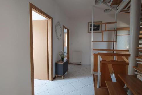 a room with a hallway with a door and a table at Klasický dům, 5 ložnic , 5 bedrooms, Praha in Prague