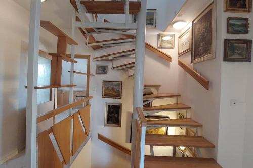 a spiral staircase in a home with wooden treads at Klasický dům, 5 ložnic , 5 bedrooms, Praha in Prague