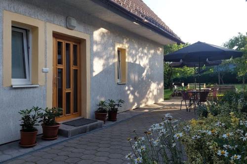 a house with a patio with a table and an umbrella at Klasický dům, 5 ložnic , 5 bedrooms, Praha in Prague