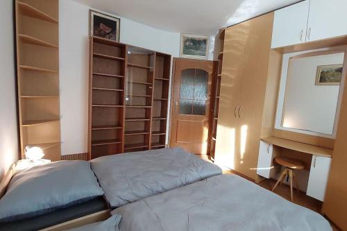 a bedroom with a bed and some shelves at Klasický dům, 5 ložnic , 5 bedrooms, Praha in Prague