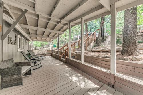 an empty porch of a house with rocking chairs at 6 Mi to Ski Cloudcroft Home with Fire Pit and Grill in Cloudcroft
