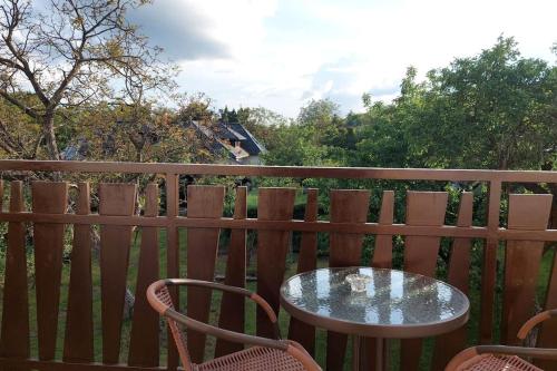 a table and two chairs on a wooden deck at Klasický dům, 5 ložnic , 5 bedrooms, Praha in Prague