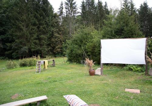 a large white screen in a field with trees at Chata Na Palouchu in Komorovice