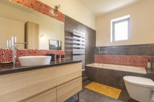 une salle de bain avec un lavabo, des toilettes et une baignoire dans l'établissement Mas Le Cerf, à Eyragues