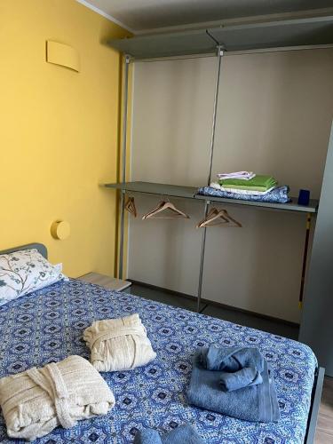 a bedroom with a bed with towels on it at Donna di Coppe Apartment in Torre Boldone
