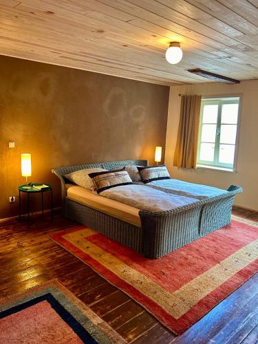 a bedroom with a large bed with a wooden ceiling at Das Brunnenhaus in Tangermünde