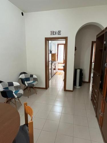 a living room with a table and chairs and a room at La Casina di Ezio in Montepulciano