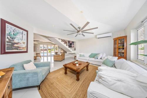 a living room with white furniture and a ceiling fan at Villa Sol Y Luna - Near Malmok Beach By Lucha in Palm-Eagle Beach
