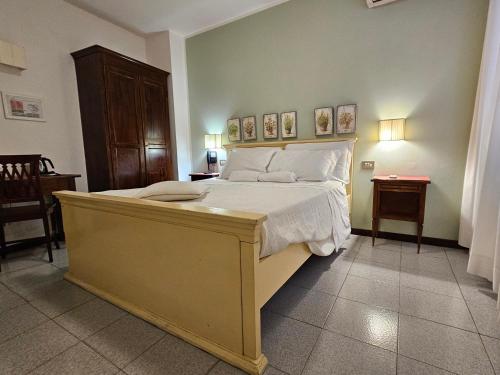 a bedroom with a large bed with white pillows at Hotel Rosalba Perugia in Perugia