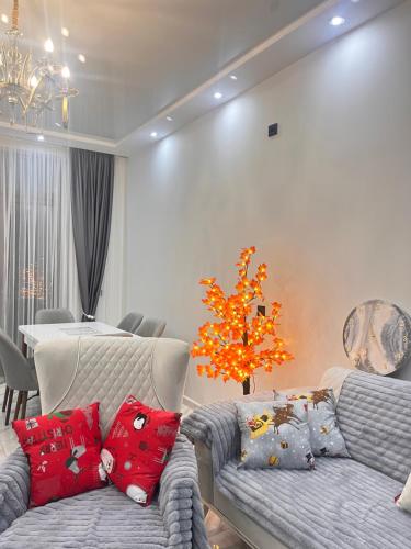 a living room with two couches and a tree at Villa Sunrise in Kapreshumi