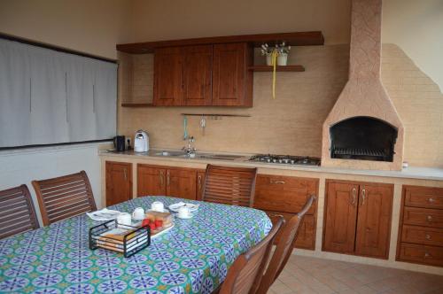 a kitchen with a table with a blue and white table cloth at B&B e Casa Vacanza al Castello in Roccella Ionica