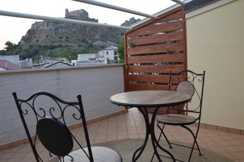 a table and two chairs on a balcony with a view at B&B e Casa Vacanza al Castello in Roccella Ionica
