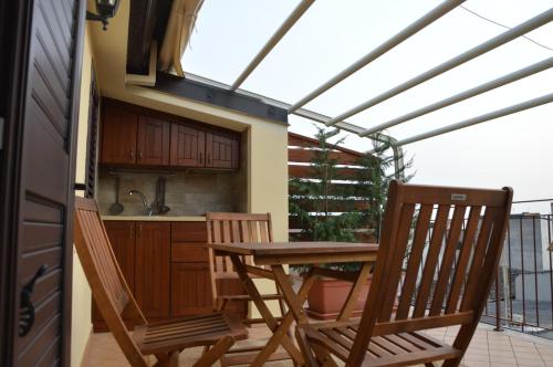 a kitchen with a table and chairs on a balcony at B&B e Casa Vacanza al Castello in Roccella Ionica