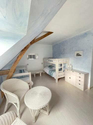 a bedroom with two beds and a table and chairs at Closerie 3 étoiles La Poire à Loup, Domaine avec Piscine in Vaulandry