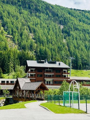 a large building in front of a mountain at Charming Apartment Chamonix Valley in Vallorcine