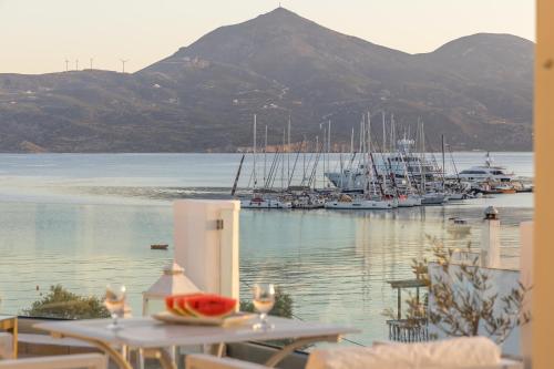 a table with a bowl of watermelon sitting on top of a marina at Ostria Hotel  in Adamas