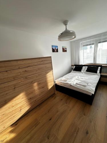 a bedroom with a bed and a large wooden headboard at Warsaw View Residance in Warsaw